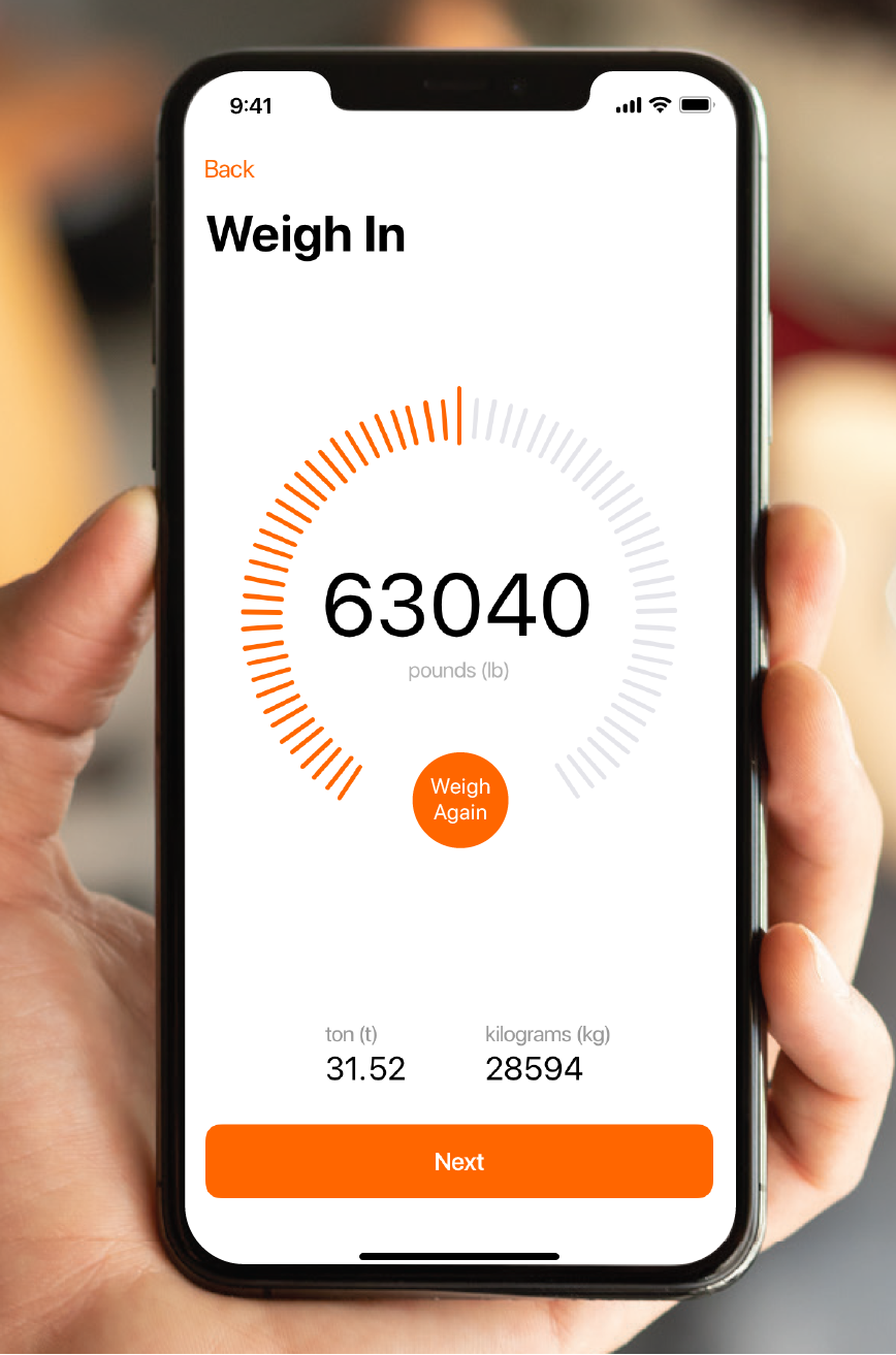 Phone with a weighing now screen open from truckpay mobile app